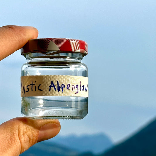 "Lenfantvivant Mystic Alpenglow art installation" "Satirical Swiss mountain air in a jar by Lenfantvivant" "Conceptual art critiquing consumer culture" "Lenfantvivant's mockery of commodified intangibles" "Mystic Alpenglow sculpture representing emptiness"